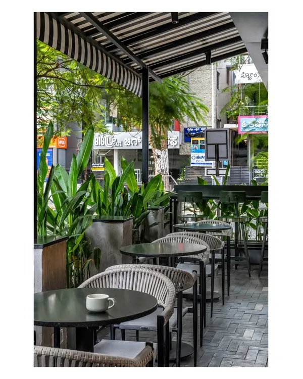 Outdoor seating is a quintessential part of the Bangalore experience. We designed this patio to feel like a natural extension of the cafe, framed by greenery to create a relaxed, refreshing vibe for lingering over coffee.