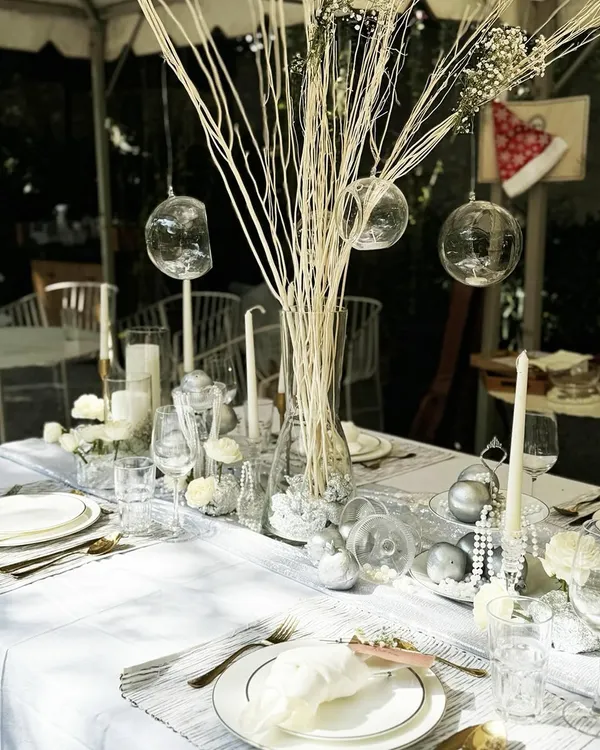 For our tablescape workshop, we created this ethereal winter wonderland theme. The setting features a clean white linen, silver accents, delicate glassware, and a centerpiece of white branches and glass baubles for a look of pure elegance.
