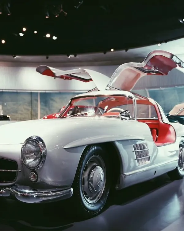 A classic Mercedes-Benz 300 SL Gullwing, a true icon of automotive history. I wanted to capture the elegance of its open doors and the vintage feel of the museum setting.