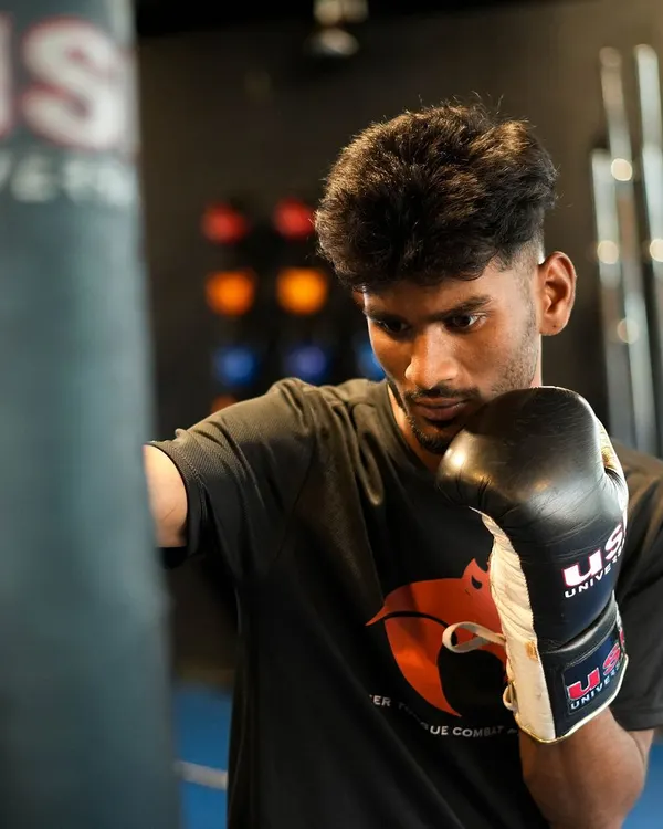 A fighter works on his punches with the heavy bag. This drill is fundamental for improving punching power, technique, and cardiovascular endurance, all while relieving stress.