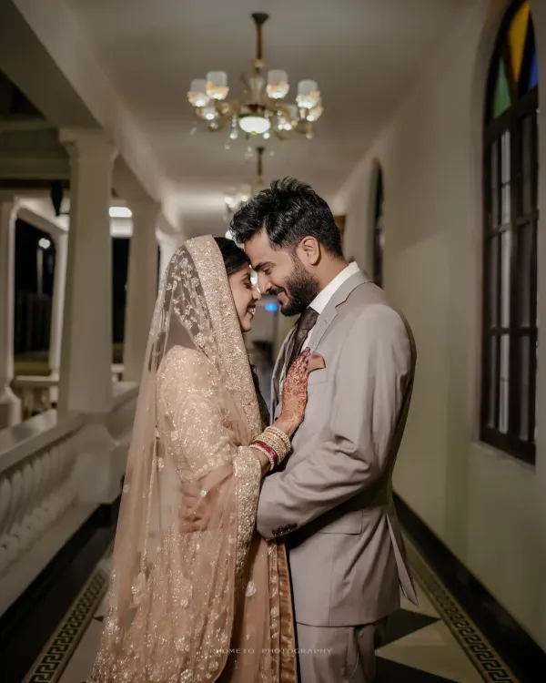 A tender, intimate moment between the couple during their Walima celebration, their smiles reflecting pure happiness.