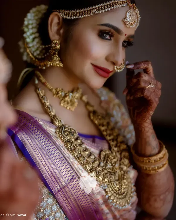 Heritage with a hint of now. Bride Priya in her luminous gold reception blouse, crafted in net and raw silk with embroidery that glows.