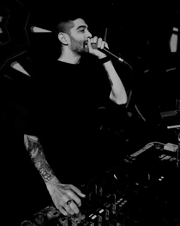 A dramatic black and white photo of me on the mic, hyping up the crowd. Using the microphone is a key part of my performance style, allowing me to connect with the audience and direct the party's energy.