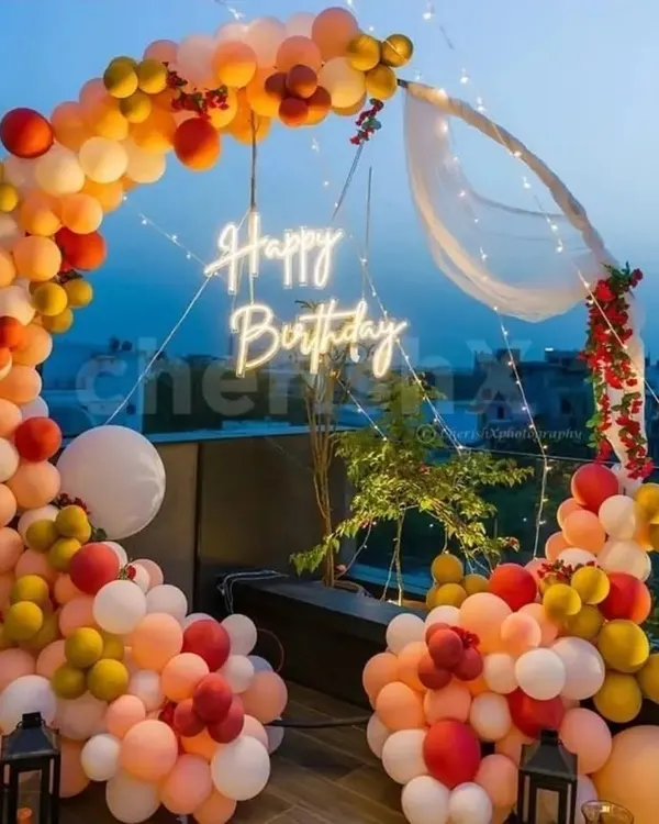 A duplicate image of the gorgeous sunset terrace party. The warm-toned balloon arch, neon sign, and city view create a perfect party atmosphere.