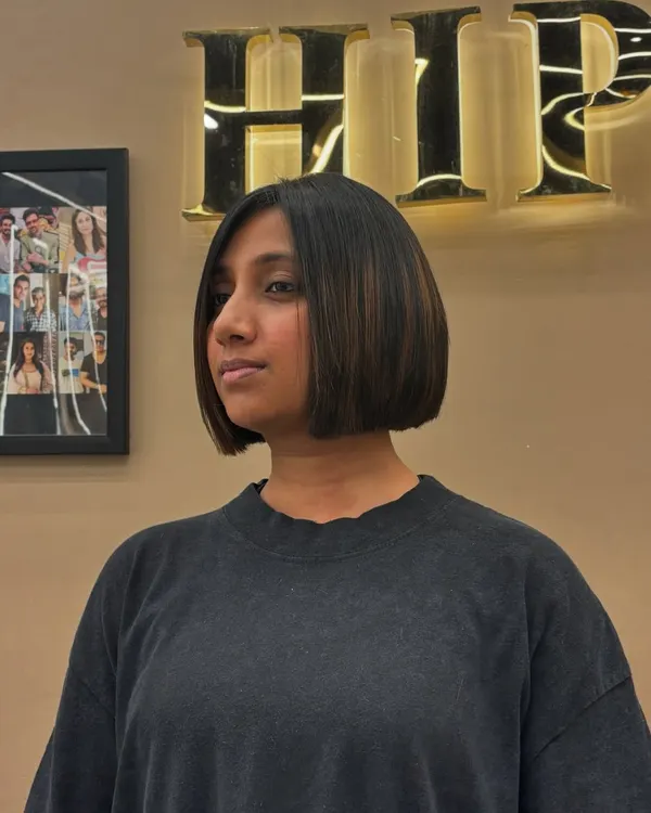 A chic and polished bob haircut with subtle highlights. This angle shows the clean lines of the cut and how the color adds just the right amount of dimension.