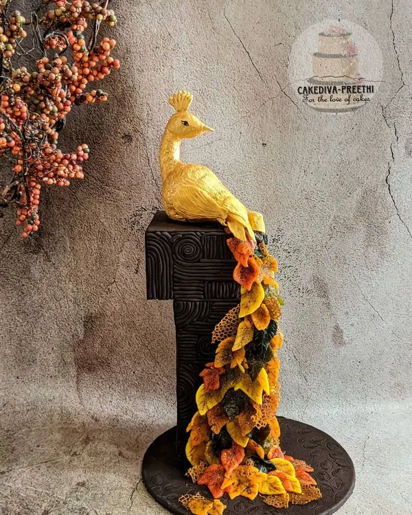 This 24-inch tall, fall-themed peacock cake is one of my proudest artistic achievements. The entire structure is cake, and the cascading feathers are crafted from delicate sugar sheets, showing the intricate, large-scale work I love to create.