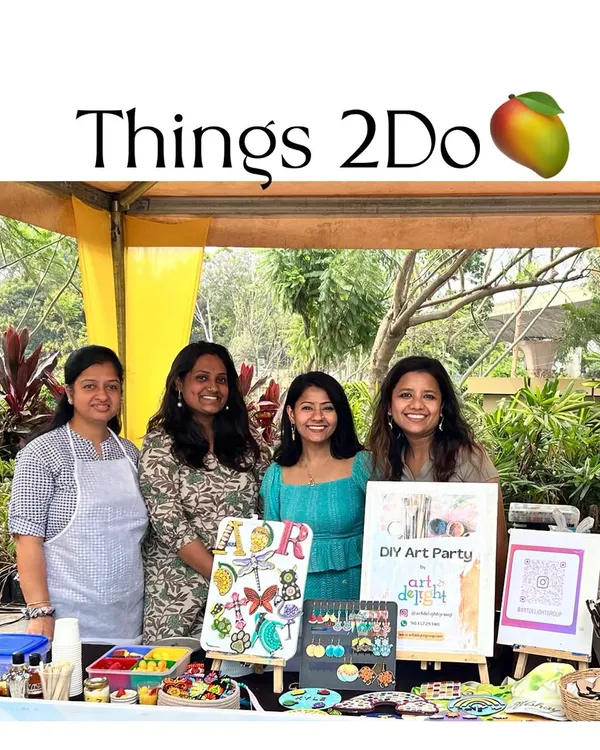 Our stall at the Things 2 Do event was buzzing with creativity. Here I am with my amazing co-artists, surrounded by handmade candles, dot mandala art, and personalized crafts.