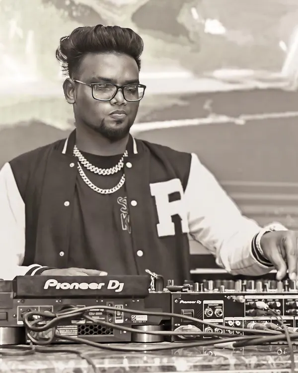 A black and white shot of me focused on the mixer. Every adjustment is about perfecting the sound for the dance floor.