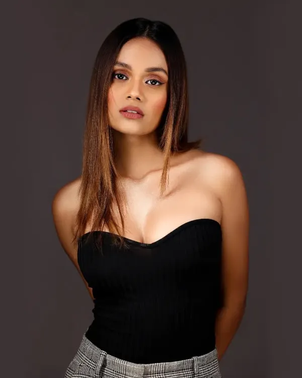 A classic headshot of a model with a direct and engaging gaze, set against a clean, solid grey background. This is the kind of professional and polished headshot I deliver for portfolios.