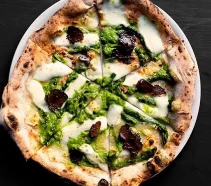 Our Pizza Al Tartufo, made with a slow-fermented dough and topped with burrata, truffle oil, and hazelnut gremolata. This is a star offering from our live pizza station.