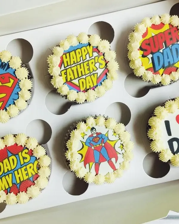 This Father's Day set features edible prints with a fun, retro comic book theme. The "Super Dad" and "Daddy is My Hero" designs are printed on edible paper and placed on rich chocolate cupcakes with a border of vanilla buttercream.