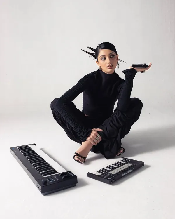 A stylized shot from a promo shoot for my debut track. I'm pictured with my portable MIDI keyboards, essential tools for sketching out melodies and basslines whether I'm in the studio or on the move.