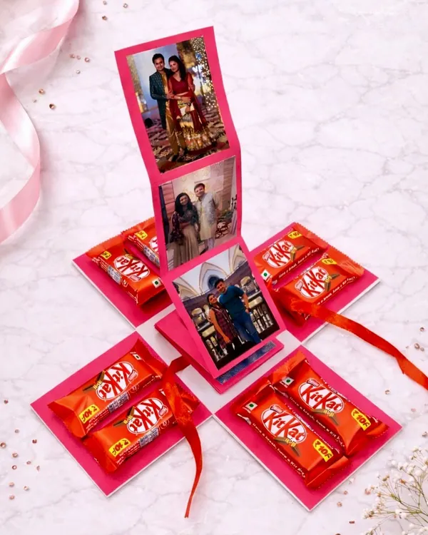 A surprise that opens up with love. This handmade photo explosion box features a waterfall of your favorite pictures in the center, with KitKat chocolates hidden in every corner.