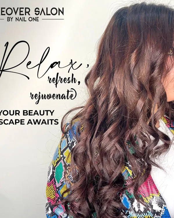 This image showcases a beautiful blowout on long, colored hair. The soft, bouncy curls add volume and glamour, perfect for a special occasion or just to feel fabulous.