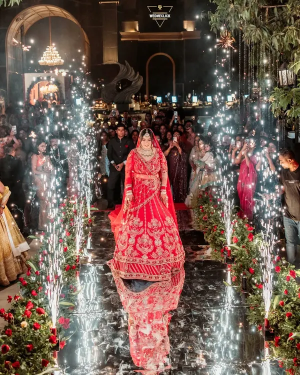 A truly magical bridal entry. The bride walks down a reflective aisle lined with cold pyro, her reflection creating a stunning visual as she moves towards her future.