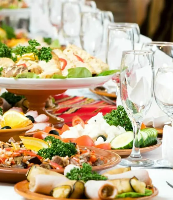We believe a beautifully set table is the start of a wonderful meal. This spread showcases a variety of our custom dishes, from fresh salads to rich main courses, all elegantly presented for a corporate event.