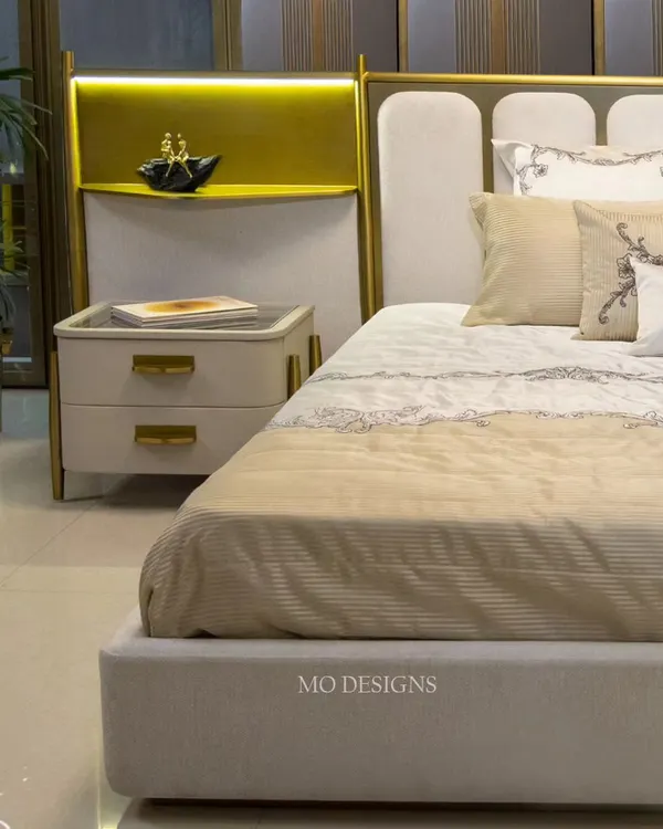 The Solitaire bed is designed to be the focal point of the bedroom. It features a unique headboard with elegant curves and integrated metal shelving with lighting, blending comfort and aesthetics while providing ample storage and style.