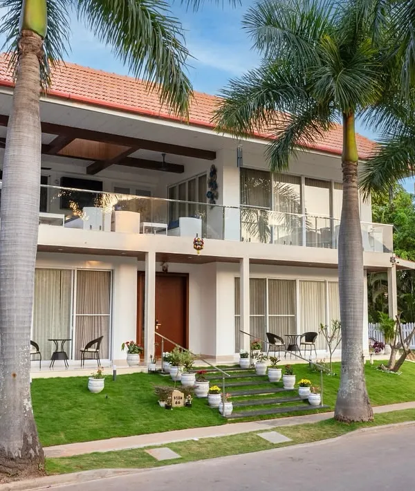 This villa is a stunning blend of modern elegance and tropical charm, with spacious balconies and lush green surroundings designed to elevate outdoor living.