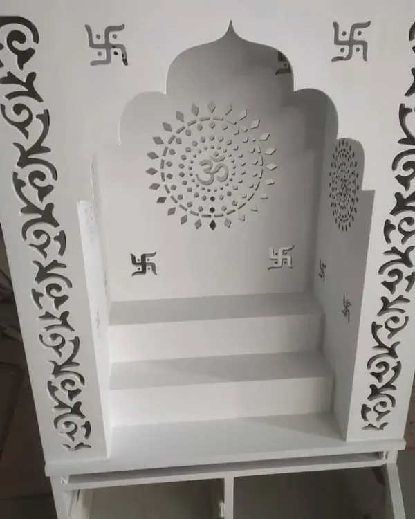 A beautiful and modern pooja unit (mandir) for the home, crafted with CNC-cut jali work featuring 'Om' and Swastik symbols.