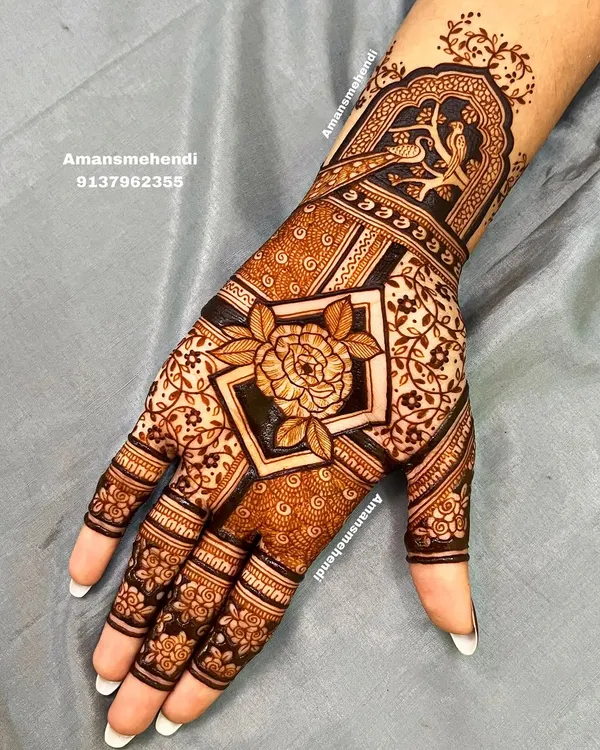 A beautiful design with a large rose as the centerpiece. The wrist is adorned with a traditional jharokha containing two birds, blending floral and architectural elements.