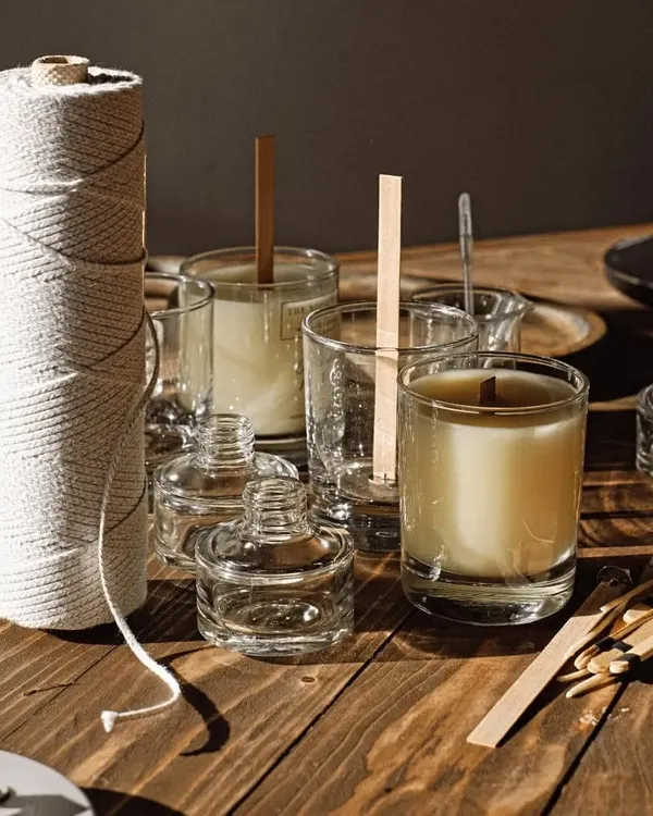 This is where the magic happens! I believe in making something that's truly yours. This behind the scenes look shows the different components you can choose from, including various glass jars, cotton wicks, and even crackling wooden wicks, to build your perfect handmade candle.