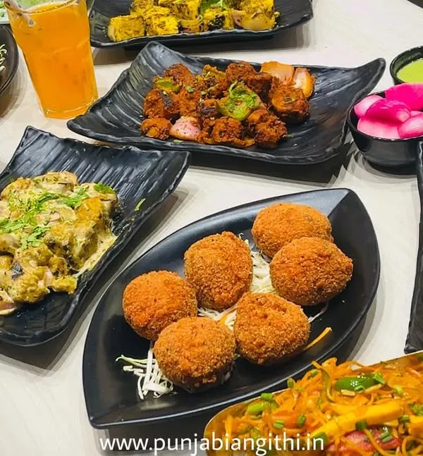 This is what pure happiness looks like. A full table with our greatest hits: crunchy Kurkure Momos, spicy Tandoori Chaap, creamy Malai Chaap, classic Paneer Tikka, and so much more. I make sure your party has a taste of everything, so no one gets FOMO.