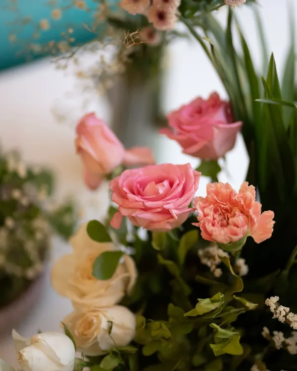 A close-up of a delicate floral arrangement featuring pink roses and carnations. These small details, when thoughtfully placed, contribute to the overall beauty and elegance of an event.