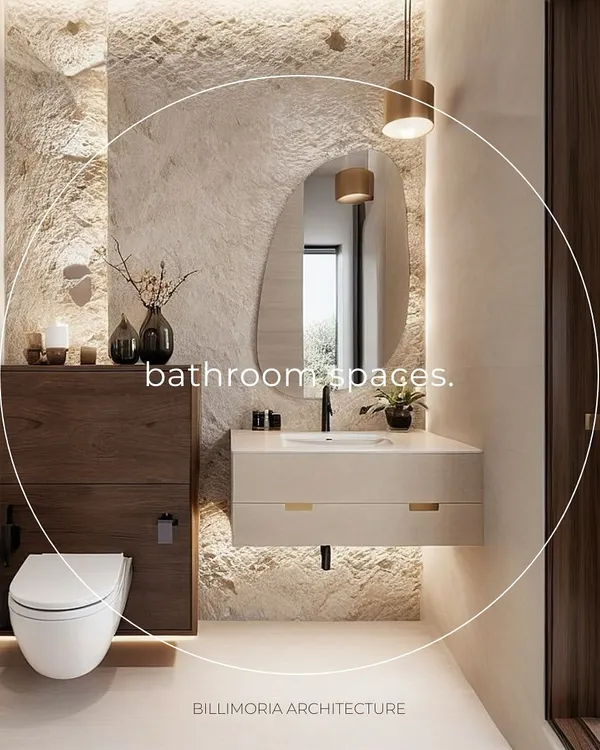 This bathroom design features a stunning rough-textured stone accent wall, beautifully highlighted with indirect lighting. The floating wooden vanity and minimalist fixtures create a perfect balance of rustic and modern aesthetics.
