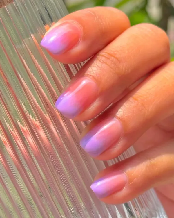 A vibrant and summery ombré effect, blending from a peachy pink at the cuticle to a lovely lavender at the tip, all with a glossy finish.