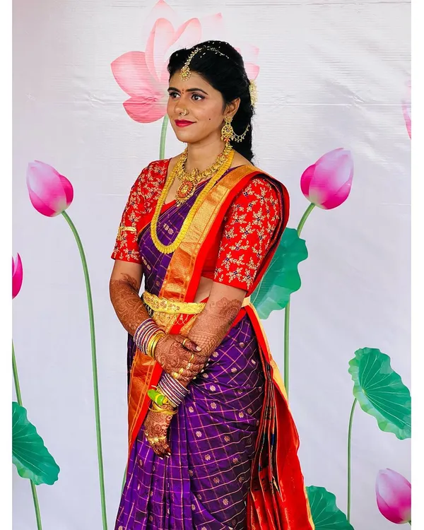 My beautiful client Dixita, ready for her pellikuthuru function. For this Telugu pre-wedding ceremony, we chose a classic look with a bold red lip and defined eyes to complement her vibrant purple and red silk saree.