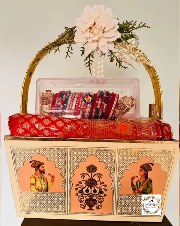 This custom Rajwadi-themed basket is one of my favorite creations for a bride's wedding trousseau. I used traditional Raja Rani motifs and elegant floral arrangements to pack the bridal saree and chuda, creating a truly royal presentation for her special day.