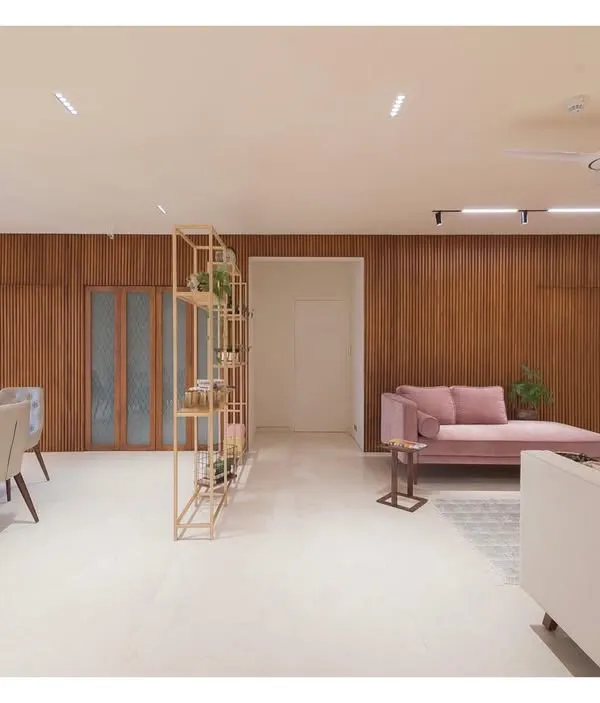 This open-plan living and dining area from the Fluted House project embodies my love for clean lines and textured surfaces. The fluted teakwood wall serves as a warm, natural backdrop, while the layout creates a simple, uncluttered floor plate for a complex and inviting space.