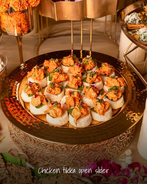 A modern Indian classic, reimagined. These Chicken Tikka Open Sliders are served on soft, fluffy bread, offering a familiar yet elevated bite that's always a crowd-pleaser at parties.