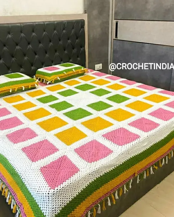 This complete handmade bed set, featuring a colorful granny square bedspread and two matching pillowcases, was a custom project. You can choose your own colors to create a unique look for your bedroom.
