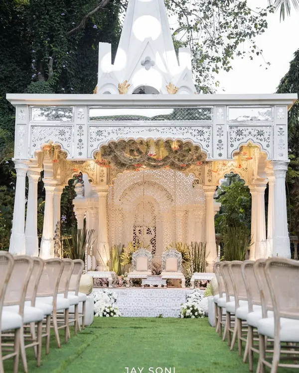 A view down the aisle towards the breathtaking mandap I designed for the Birla wedding. The structure was inspired by classic Indian architecture, creating a regal and timeless setting for the ceremony.
