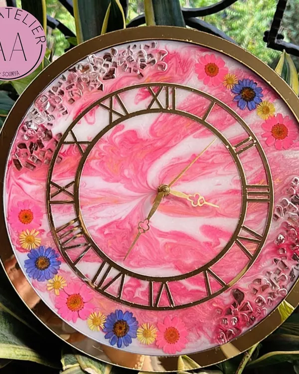 My first ever resin clock. This piece features a pink marble effect with real flowers and crystals, a design that started my love for making custom timepieces.