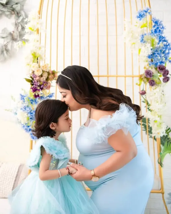 A quiet promise between a mother and her daughter. We styled this session with matching ethereal blue gowns to highlight the magical connection as they await the newest family member.