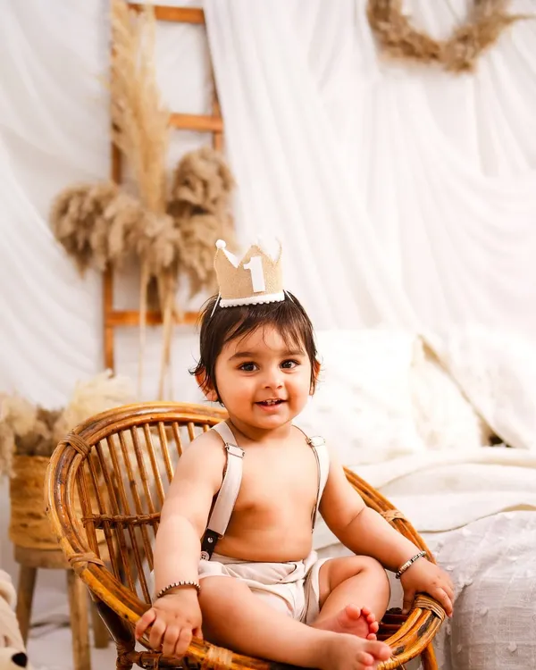 A little prince on his throne. This minimalist boho session uses natural textures like rattan and linen to create a warm and timeless first birthday portrait.