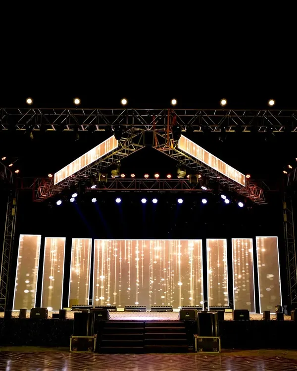 The centerpiece of a high-energy Sangeet: a massive stage with custom LED backdrops and a professional lighting rig. We design these setups to rival a live concert, ensuring every performance is spectacular.