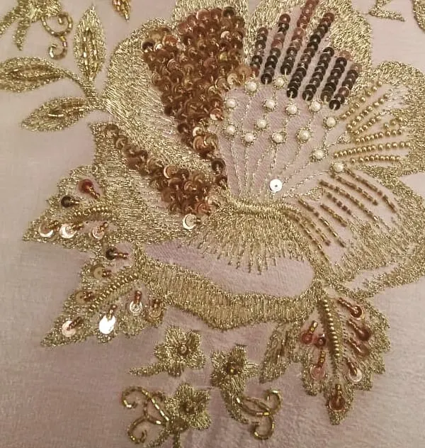 A close-up of my hand embroidery work, showing a floral motif created with shimmering sequins, delicate beads, and fine threadwork. These details are what make a custom outfit truly special.