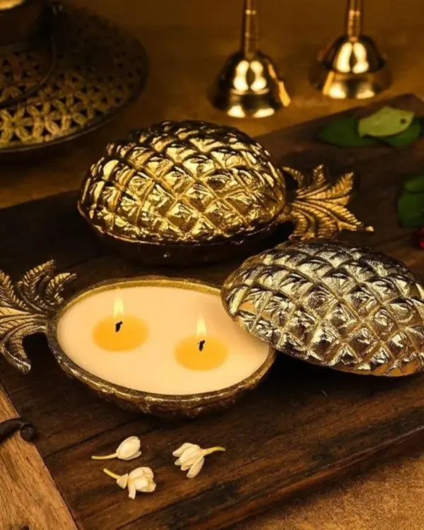 This lit, golden pineapple urli candle captures the essence of festive luxury. It's a perfect centerpiece, blending traditional charm with a modern aesthetic, ideal for high-end home decor and celebratory gifting.