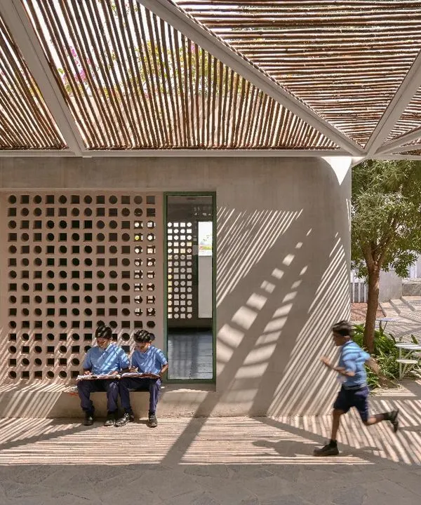 Shadow play at the Talaricheruvu Rural School. The bamboo canopy and perforated jaali walls create a constantly changing pattern of light, making the space dynamic and engaging for the children.