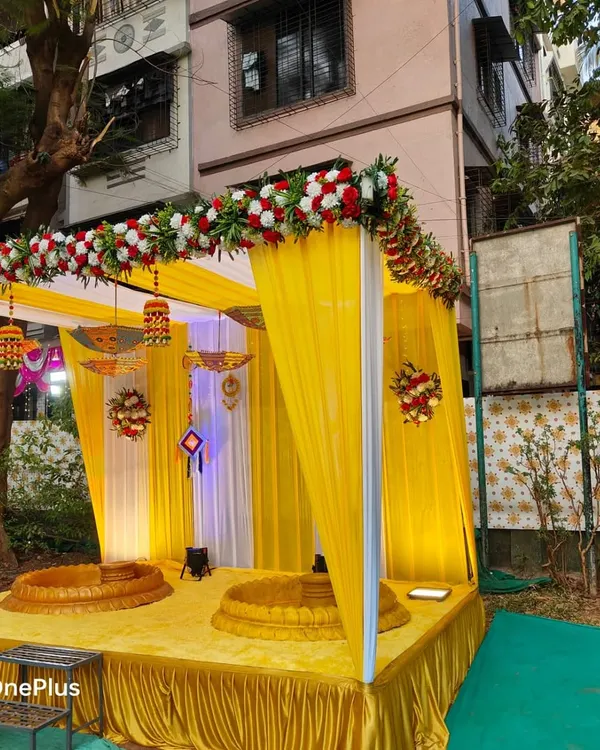 A beautiful outdoor Haldi ceremony setup. I created a mandap with yellow drapes, decorated with traditional hangings and floral arrangements, and provided two baithaks for the rituals.
