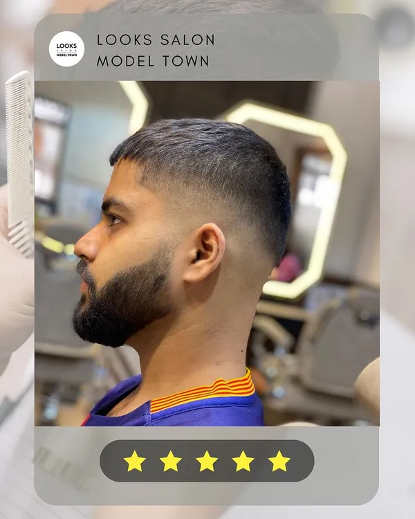 A perfect example of a modern men's haircut. This look features a sharp skin fade that blends seamlessly into a textured top, paired with a clean beard lineup.