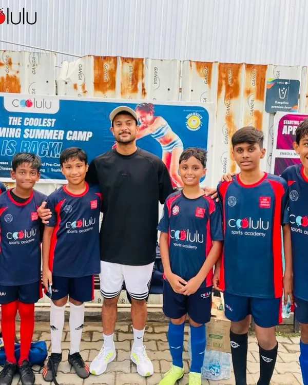 A football team photo with their coach. Our coaches are mentors who guide, support, and inspire our players to be their best on and off the field.