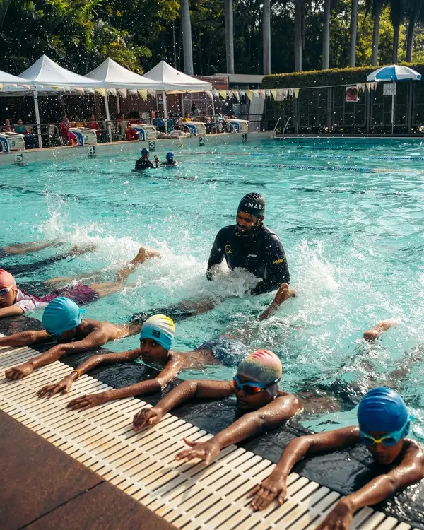 This is what our coaching is all about: hands-on guidance and creating a fun, energetic atmosphere. I believe in teaching through practice, helping young swimmers build confidence and proper kicking technique right from the start.