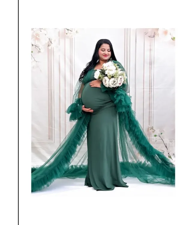 This is the essence of the maternity glow. I love capturing serene, powerful solo portraits like this one. The flowing emerald green tulle gown is part of my studio's collection, and it creates such a beautiful, dramatic effect against the soft, floral-inspired backdrop.
