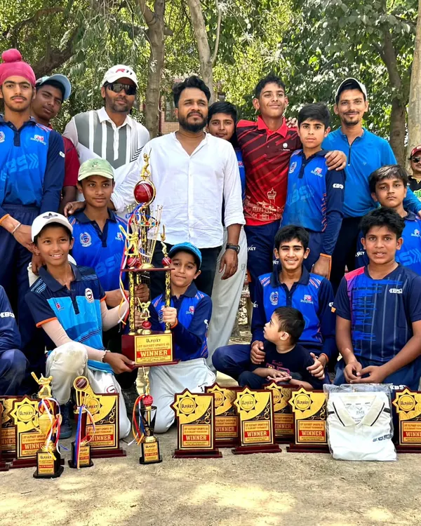 A proud moment with the team after a successful tournament. We are surrounded by the trophies that represent their hard work and dedication.