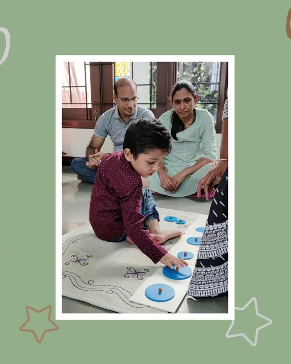 Proud parents watch as their son demonstrates his understanding of Montessori materials. Our "Show and Tell" days are a highlight, allowing children to become the teachers and share their knowledge.