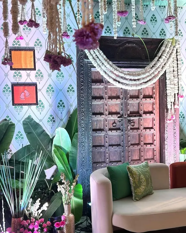 A closer look at the traditional wooden door and floral garlands, key elements of our South Indian themed baby shower decor.